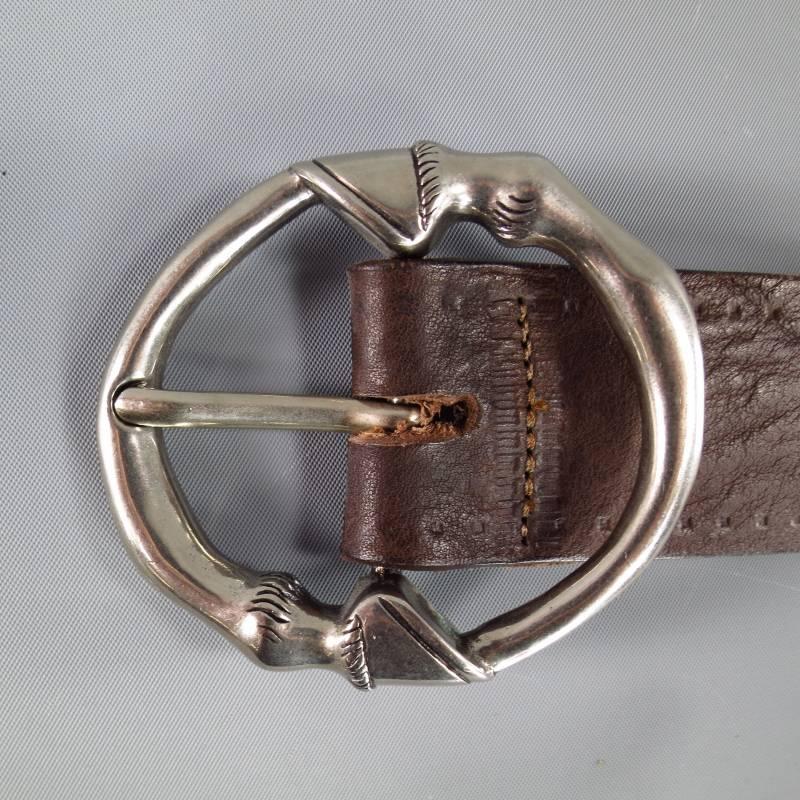 This chic GUCCI belt features a thick chocolate brown leather strap with embossed piping detail and a large silver tone circular horse hoof buckle. Made in Italy.
 
Excellent Pre-Owned Condition.
 
Measurements:
 
Length: 40.5 in.
Width: 1.5