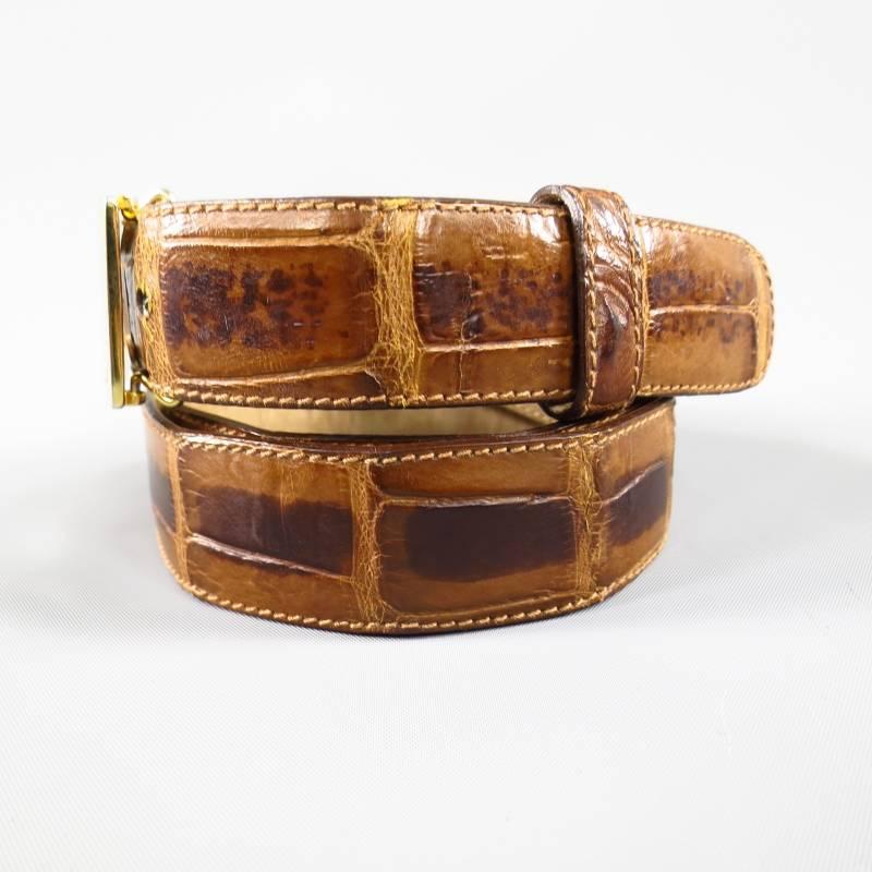 This vintage BOTTEGA VENETTA belt features a gorgeous light taupe brown alligator strap with an engraved gold tone square buckle. Made in Italy.
 
Very Good Pre-Owned Condition.     Marked: 110/95 38"
 
Measurements:
 
Length: 44