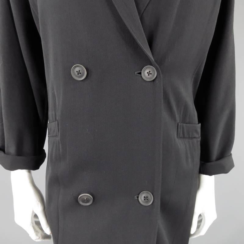 YOHJI YAMAMOTO wool overcoat features jumbo notch lapels, double breasted construction, dart detailing and an over-sized drop shoulder silhouette, made in France.

Excellent Pre-Owned Condition    Marked: Medium

Measurements:

Shoulder: 20