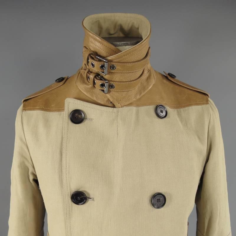 BELSTAFF Jacket consists of linen material in khaki color tone. Designed in a peacoat style, double breasted button front with brown tortoise buttons, side inseam pockets. Tan leather details can be seen on epaulette shoulders, cuffs with adjustable