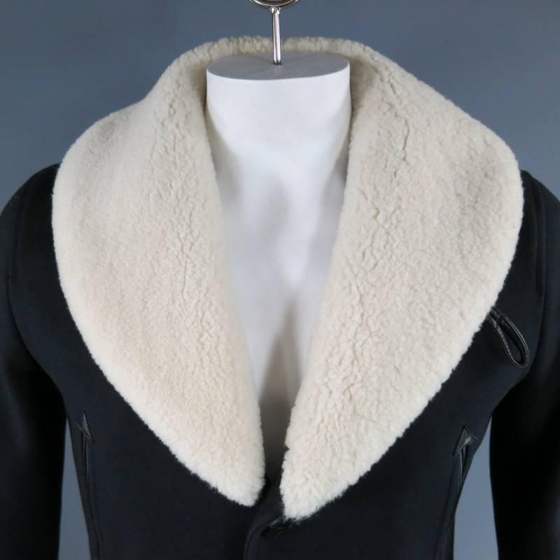 SANDRO shearling pea coat features a wide cream colored collar, 4 jetted pockets, quilted lining and brand specific tailoring in navy.
 
Excellent Pre-Owned Condition    Marked: Medium
 
Measurements:
 
Shoulder: 17 in.
Chest: 34 in
Sleeve: