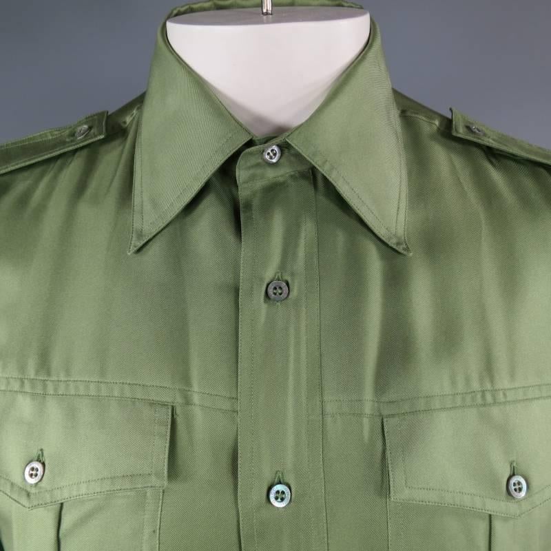 GUCCI by TOM FORD Long Sleeve Shirt consists of 100% silk material in a green color tone. Designed with a pointed collar, epaulette shoulders, button up front and multiple patch pockets. Double button cuff with tone-on-tone stitching. Made in