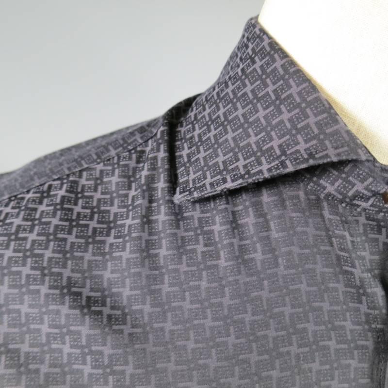ETRO Long Sleeve Shirt consists of cotton material in a charcoal color tone. Designed with a spread collar, button-up front, X-pattern throughout body in a contrast light charcoal. Single button cuffs. Made in Italy.
 
Excellent Pre-Owned