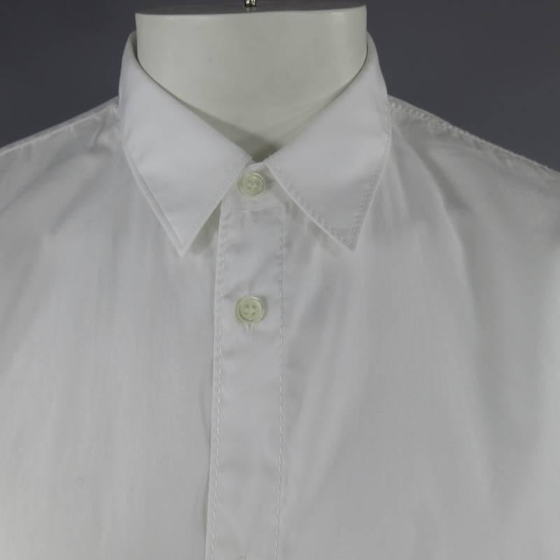 COMME DES GARCONS Long Sleeve Shirt consists of 100% cotton material in white color tone. Designed with a slim pointed collar, button-up front, patch pocket with single button cuffs. Oversize fit and tone-on-tone stitching throughout seams Uneven