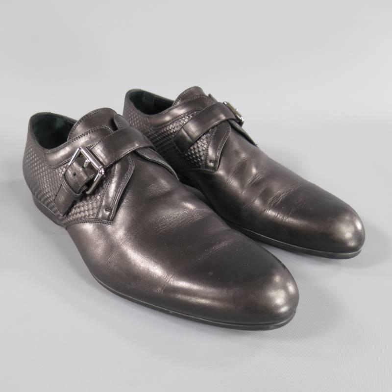 These sporty LOUIS VUITTON dress shoes come in a smooth black leather and feature a pointed toe single monk strap with silver tone logo engraved buckle, checkered Damier embossed leather back with rubber logo plaque and rubber sole. Made in Italy.
