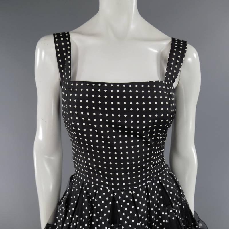 This fabulous OSCAR DE LA RENTA cocktail dress comes in black and white polka dot print silk satin and features thick straps, fitted bodice, and a full circle skirt with mesh cutouts, oversized flower embellishments, and full petticoat lining. Made