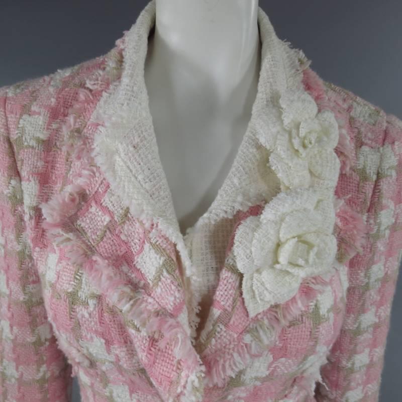This fabulous CHANEL jacket comes in a pink, white, and beige houndstooth woven boucle fabric and features  a double lapel with removable boucle Camerllia flower brooches, pink logo buttons, raw edge hems, and champagne floral print satin lining.