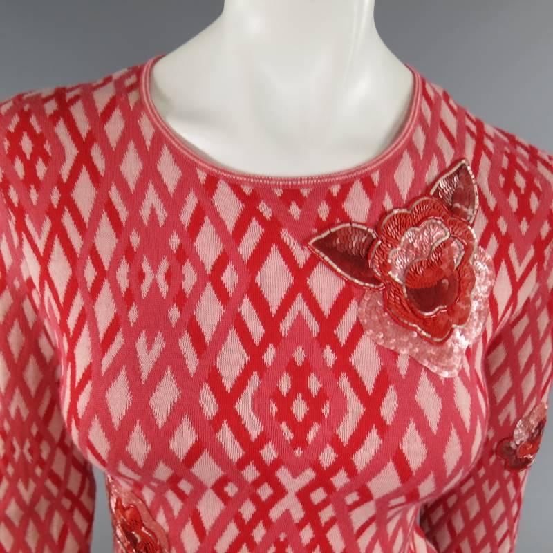 This rare CHANEL Fall 2003 Satellite Love Collection skirt set comes in a pink and red rhombus argyle pattern cashmere and includes a scoop neck top with sequin floral embellishments and a matching knit skirt with pocket and slit. Small hole shown