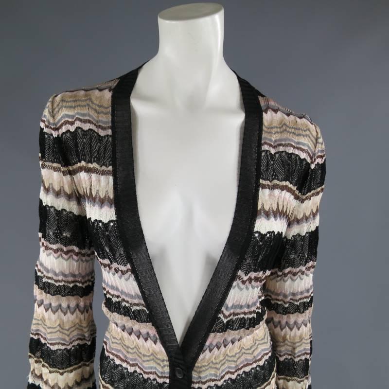 This chic MISSONI extended cardigan coat comes in a textured mesh knit in beige, gray, pink, brown, and black stripes and features a deep V neck with black sheer trim, bell sleeves, and a three button closure. Made in Italy.
 
Very Good Pre-Owned
