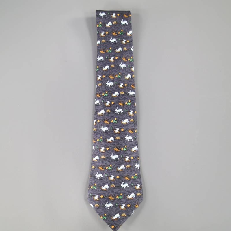 HERMES Tie consists of 100% silk material in a slate color tone. Designed with a rabbit print throughout body of tie, multi-color tones can be seen (white, orange and green). Made in France.
 
Marked: 7689 OA