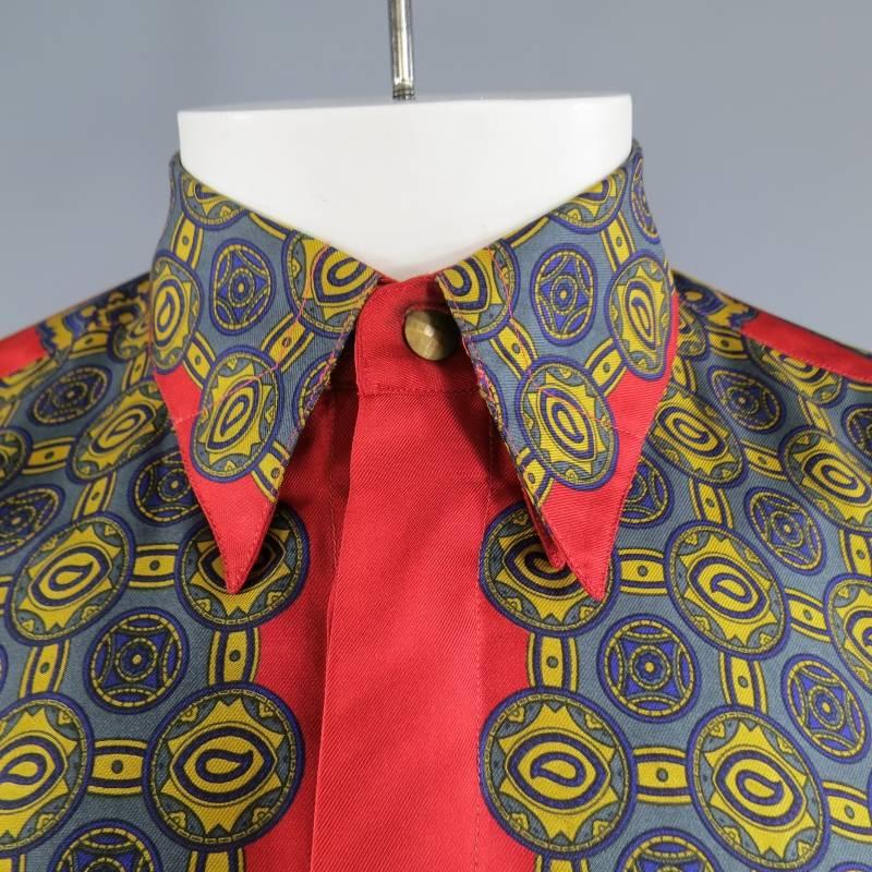 This vintage GIANNI VERSACE shirt comes in a light weight red silk twill and features a hidden placket, pointed hidden button down collar, gold and navy polka dot paisley scarf print front and square scarf print sleeves. Made in Italy.
 
Excellent