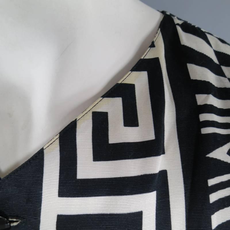 This rare & iconic GIANNI VERSACE vest comes in a black and white geometric print with a V neck and crystal buttons. In great condition with discolorations throughout. Made in Italy.
 
Fair Pre-Owned Condition.
Marked: 48
 
Measurements:
