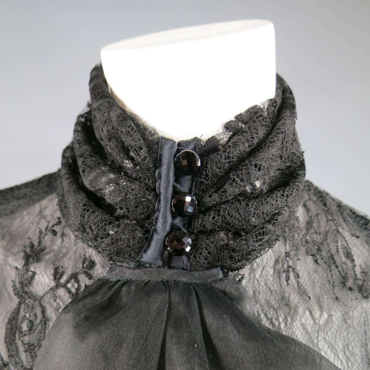This stunning vintage EMANUEL UNGARO blouse comes in a black floral lace and features a high neck with black crystal buttons, ruffled ascot accent, and dramatic pleated puff sleeves. Made in Italy.
 
Excellent Pre-Owned Condition.

