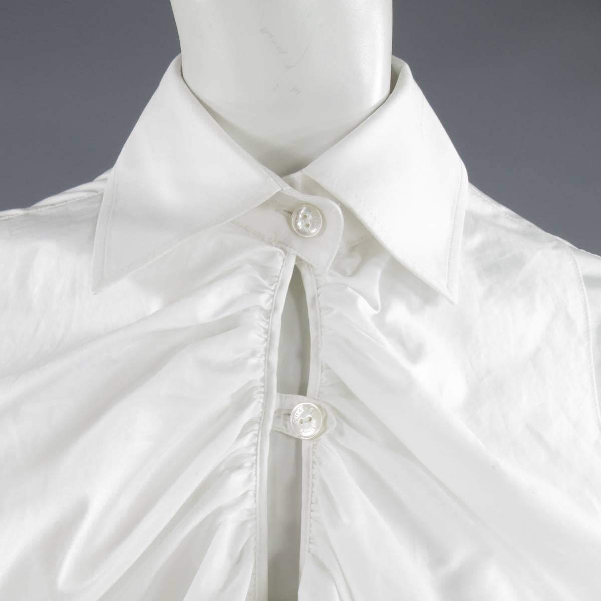 This fabulous CHANEL shirt dress comes ina light weight cotton and features a pointed collar, three quarter sleeves, and a button up closure with ruffled detail. Made in Italy.
 
Very Good Pre-Owned Condition.
Marked: 42
 
Measurements:
