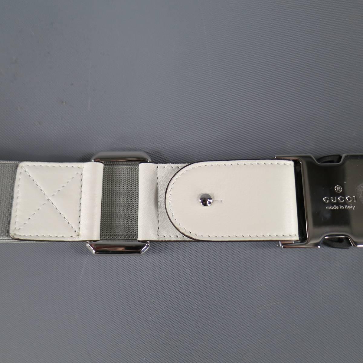 GUCCI elastic belt features utilitarian buckle design with leather accents and chrome shine hardware in gray & white, made in Italy.
 
Excellent Pre-Owned Condition    Marked: 34
 
Measurements:
 
Length: 31 in.
Width: 1.5 in.
