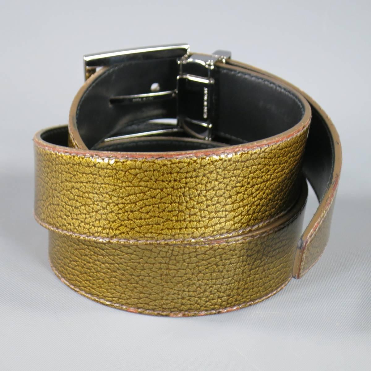 DOLCE & GABBANA dress belt is Italian leather and features an iridescent metallic upper and brand engraved plaquer in gold. Faint blemish near buckle. Made in Italy.
 
Good Pre-Owned Condition    Marked: 44
 
Measurements:
 
Length: 44