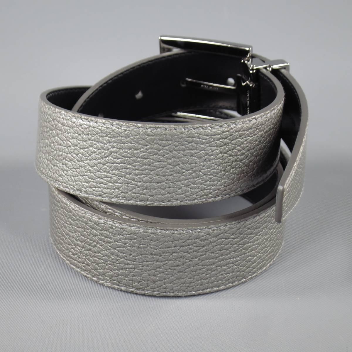 DOLCE & GABBANA dress belt is italian leather and features an iridescent metallic upper and brand engraved plaquer in silver. Faint blemish near buckle. Made in Italy.
 
Good Pre-Owned Condition    Marked: 44
 
Measurements:
 
Length: 44