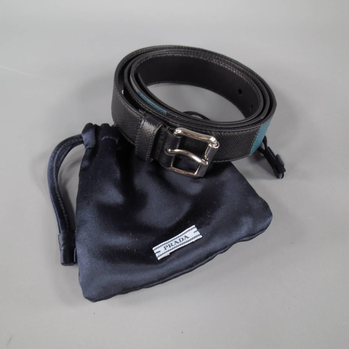PRADA casual dress belt features high shine metal hardware and minimal patchwork leather construction in black, blue, gray, and red, made in Italy.
 
Excellent Pre-Owned Condition - with dust bag -     Marked: 40
 
Measurements:
 
Total