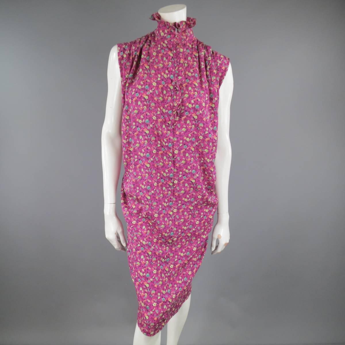 This fabulous vintage EMANUEL UNGARO dress comes a fuchsia pink floral print silk  and features a high ruffled collar with button closure, pleated shoulders, cacoon shirt silhouette, and includes a yellow floral print sash with hook eye closures for