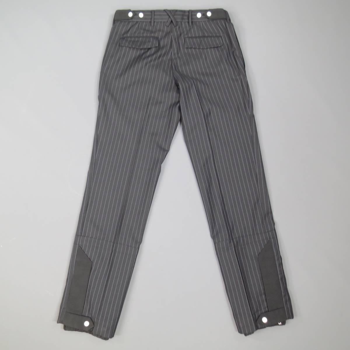 KRIS VAN ASSCHE Dress Pants consists of wool blend material in a black color toned. Designed with a zip-fly clasp closure, stripe pattern in a contrast white, side button closure pockets. Detailed with snap/zipper closure and elastic jogger on leg