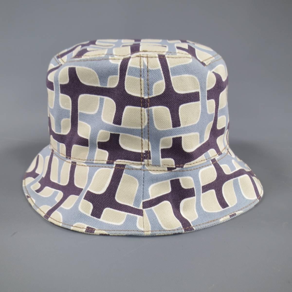 This rare PRADA bucket hat comes in a unique light blue, khaki, and brown geometric retro 