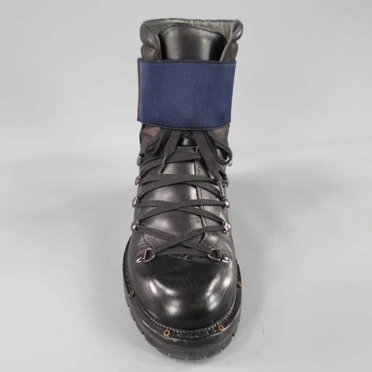 These ultra chic LANVIN Mountain boots come in smooth black leather and feature a wide lace up front with gunmetal tone prongs designed after a traditional hiking boot, thick, elastic velcro strap in navy blue, thick hiking sole with metal plate
