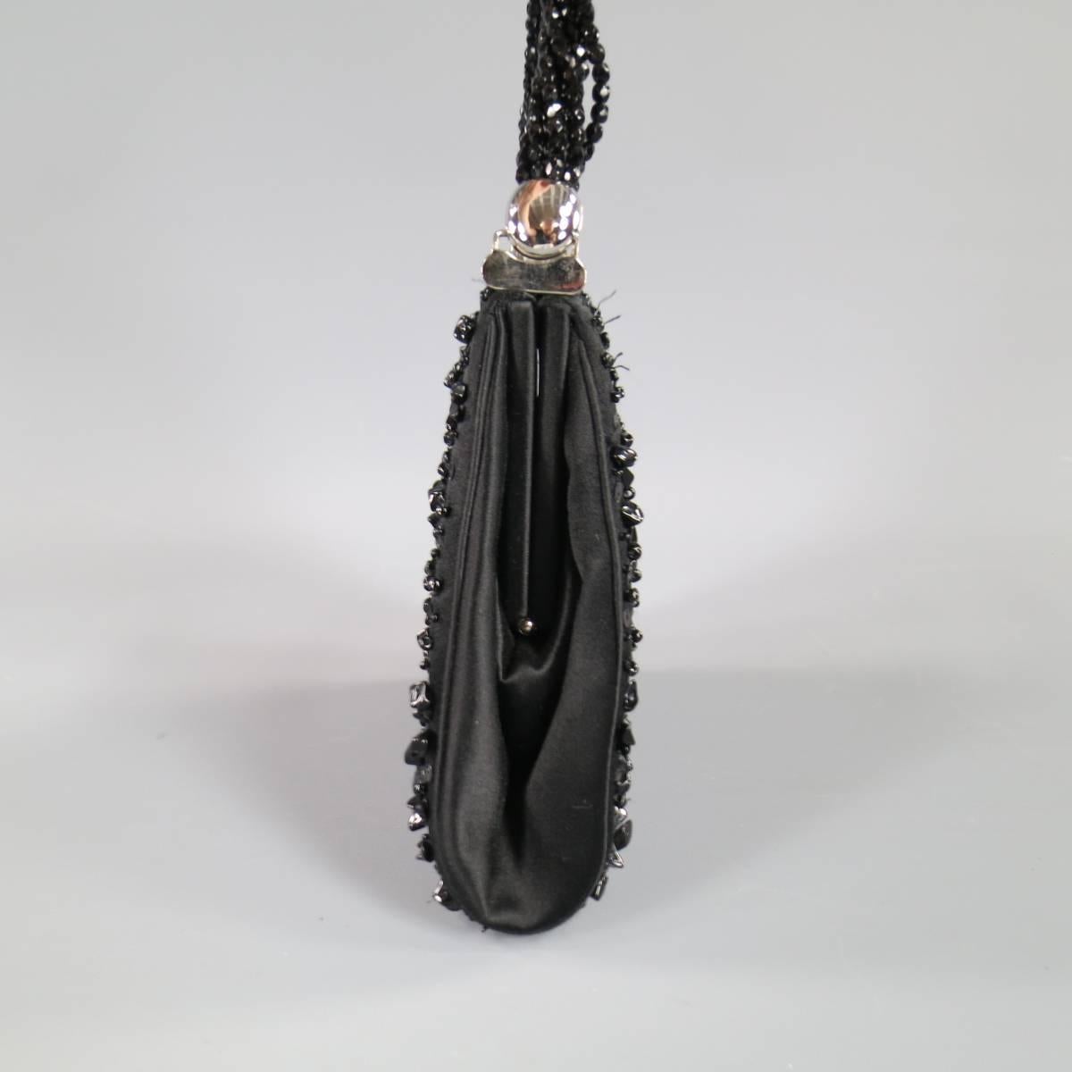 This vintage JUDITH LEIBER evening bag comes in black satin covered in various pebble, sequin, and circle beads, with a silver tone black crystal studded closure, and beaded strand handle. This piece comes in 