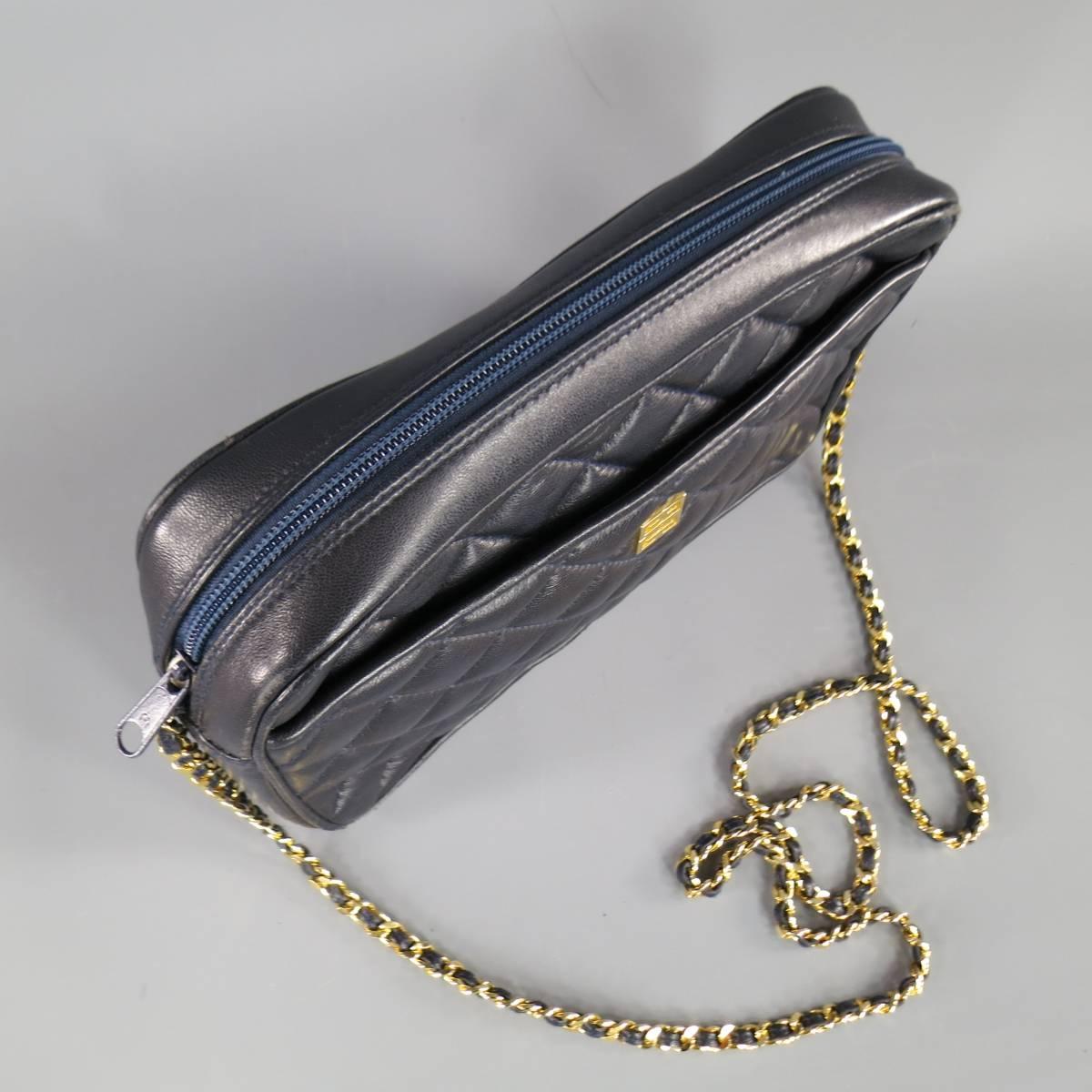 This vintage GIVENCHY shoulder bag comes in quilted navy leather and features the classic G logo in yellow gold hardware and a long gold chain strap with leather weaving. Natural wear on leather in detail shots.
 
Good Pre-Owned Condition.

