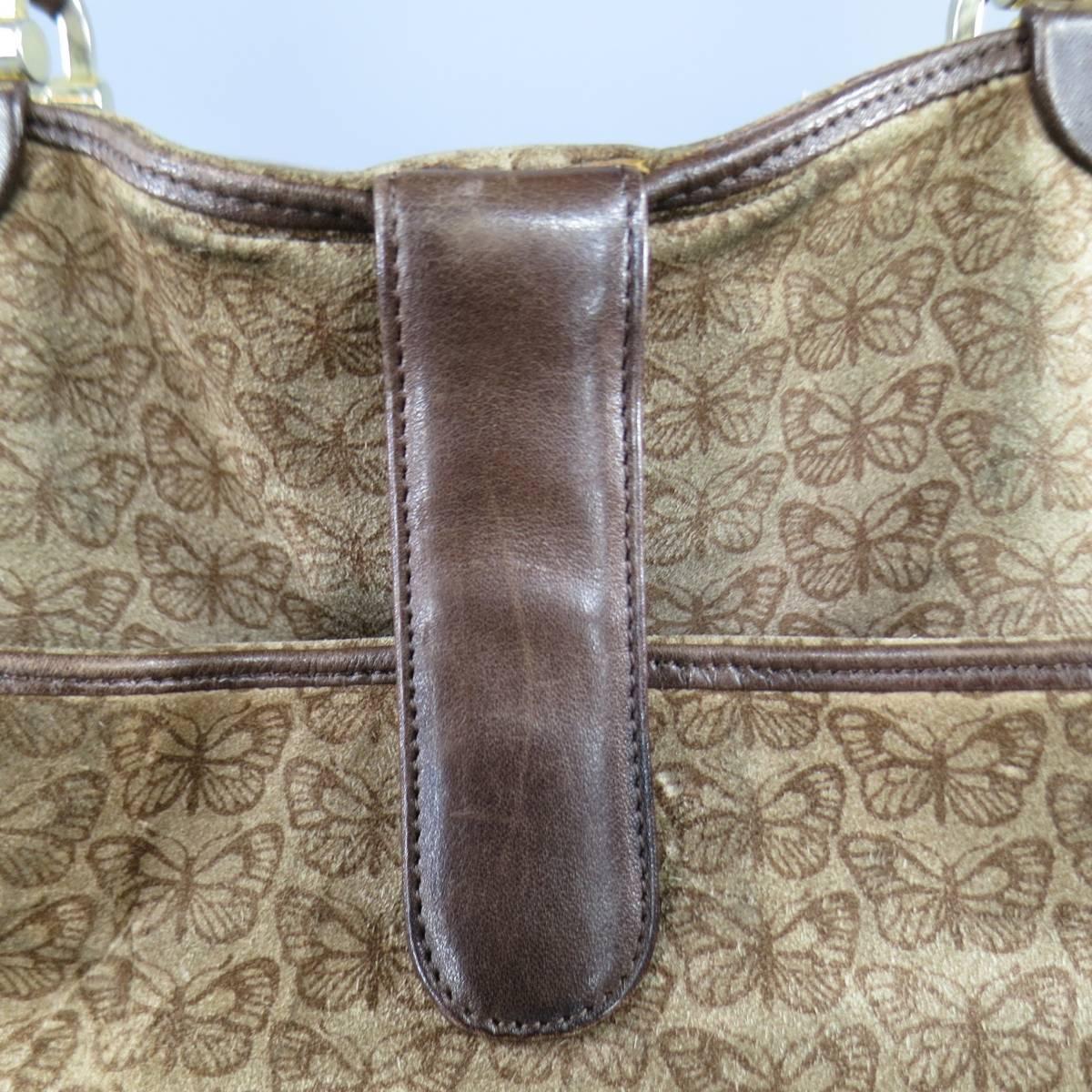 This vintage BOTTEGA VENETA tote bag comes in light taupe brown suede with all over butterfly print and features brown leather piping, double top handles with light gold tone hardware, and snap closure. In as-is condition with wear shown in detail