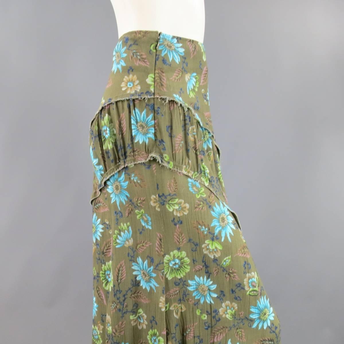This rare Y'S by YOHJI YAMAMOTO maxi skirt comes in a light weight olive green textured rayon with blue and brown floral and leaf print and features diagonal curved panels with raw edges and gathering. Made in Japan.
 
Excellent Pre-Owned