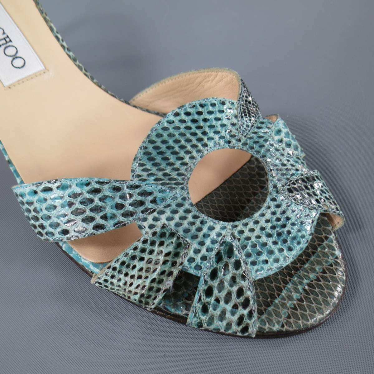 These fabulous JIMMY CHOO sandals come in light aqua teal snake skin leather and feature a thick cutout O strap, peep toe, and covered stiletto heel. Made in Italy.
 
Good Pre-Owned Condition.
Marked: 39
 
Measurements:
 
Length: 10