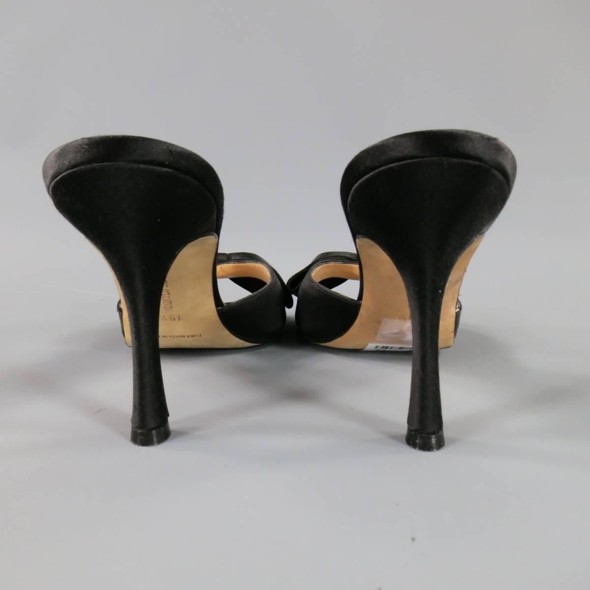 These gorgeous MANOLO BLAHNIK mules come in black silk satin and feature a peep toe strap with large bow detail and covered stiletto heel. Unworn with anti slip sole added. Made in Italy.
 
Excellent Pre-Owned Condition.
Marked: 39 1/2
