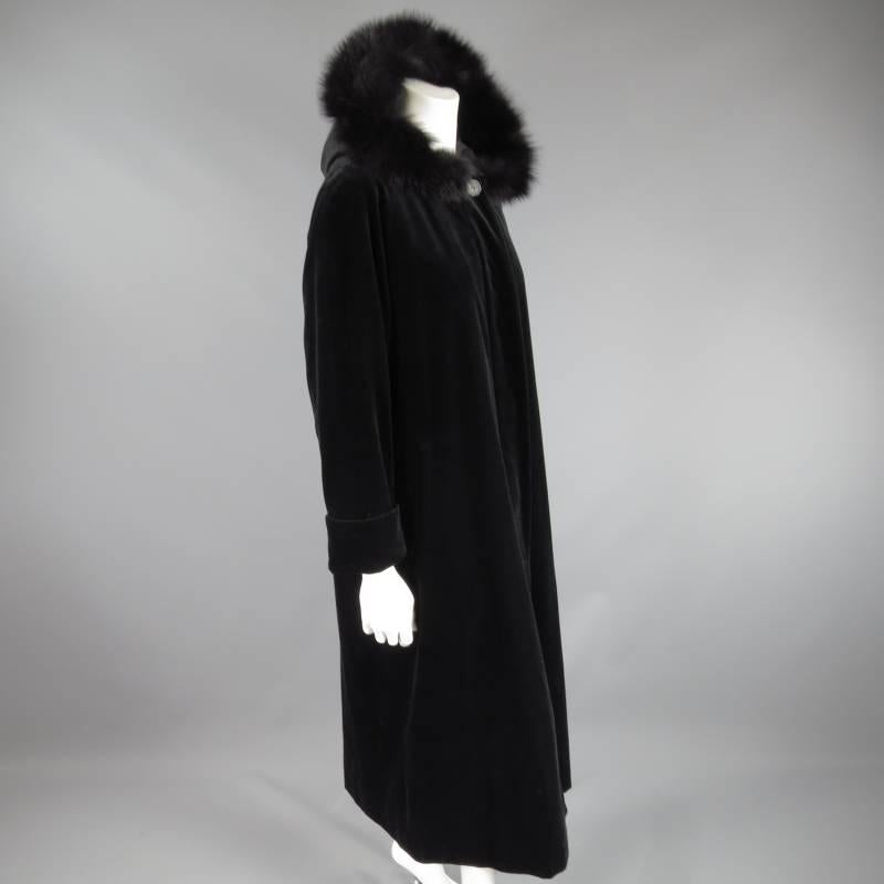 This vintage BURBERRY coat comes in a luscious back velvet and features a button up closure with hidden placket, thick cuffed sleeves, frontal slit pockets, A line silhouette, and detachable fox fur trimmed hood.
 
Excellent Pre-Owned Condition.  