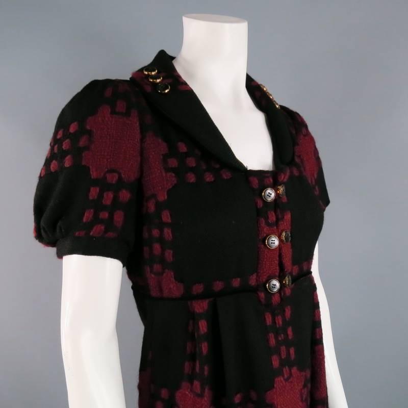 This fabulous fall/winter GUCCI dress comes in a textured black and burgundy wool knit material with a button detailed round lapel collar, short, pleated puff sleeves, empire waist, and pleated shift skirt with pockets. Made in Italy.
 
Excellent