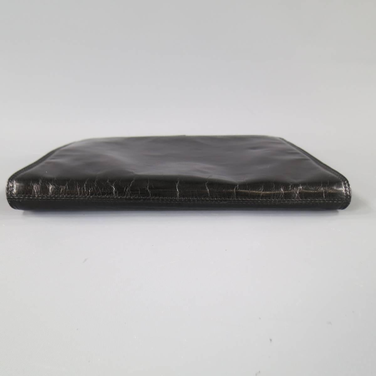 This vintage BOTTEGA VENETA clutch comes in smooth shiny black leather with a clip lock closure, leather lining with zip pocket and brown engraved mirror. Made in Italy.
 
Excellent Pre-Owned Condition.
 
Measurements:
 
Length: 11.25