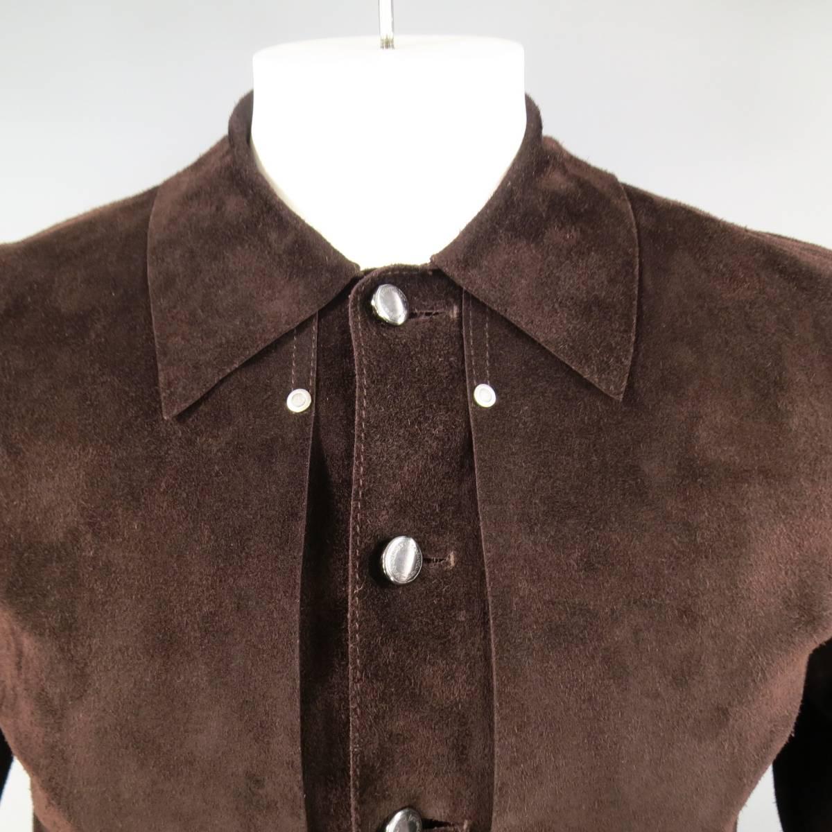 This impeccable YVES SAINT LAURENT cropped trucker style jacket comes in rich, chocolate brown distressed suede and features a raw edge pointed collar, frontal overlay panels with silver tone stud details, engraved buttons, internal button panel,