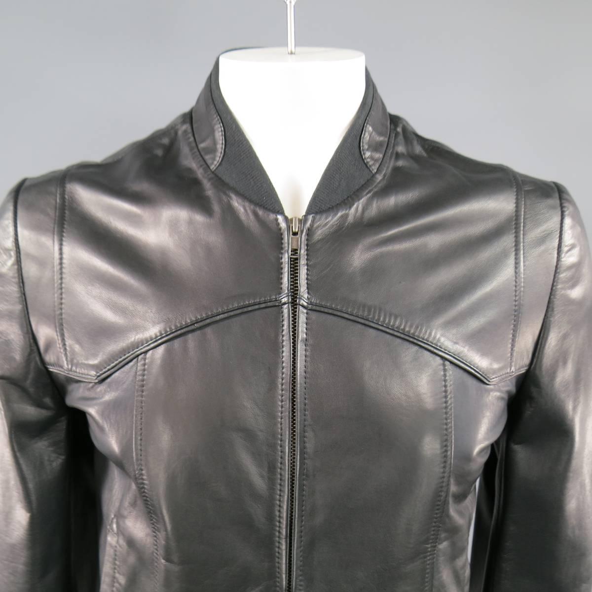 MAISON MARTIN MARGIELA Jacket consists of leather material in a black color tone. Designed with a zipper front, rib collar, tone-on-tone stitching throughout body and single snap cuffs. Detailed with side inseam pockets. Made in Italy.
 
Very Good