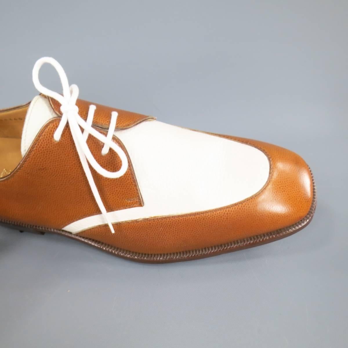 These deadstock vintage GRAVATI dress shoes come in tan and white pebbled leather with a brown midsole and golf spike sole. Minor discoloration on right toe shown in detail shots. Made in Italy. Retails at $565.00.
 
New in Box (Deadstock Vintage)