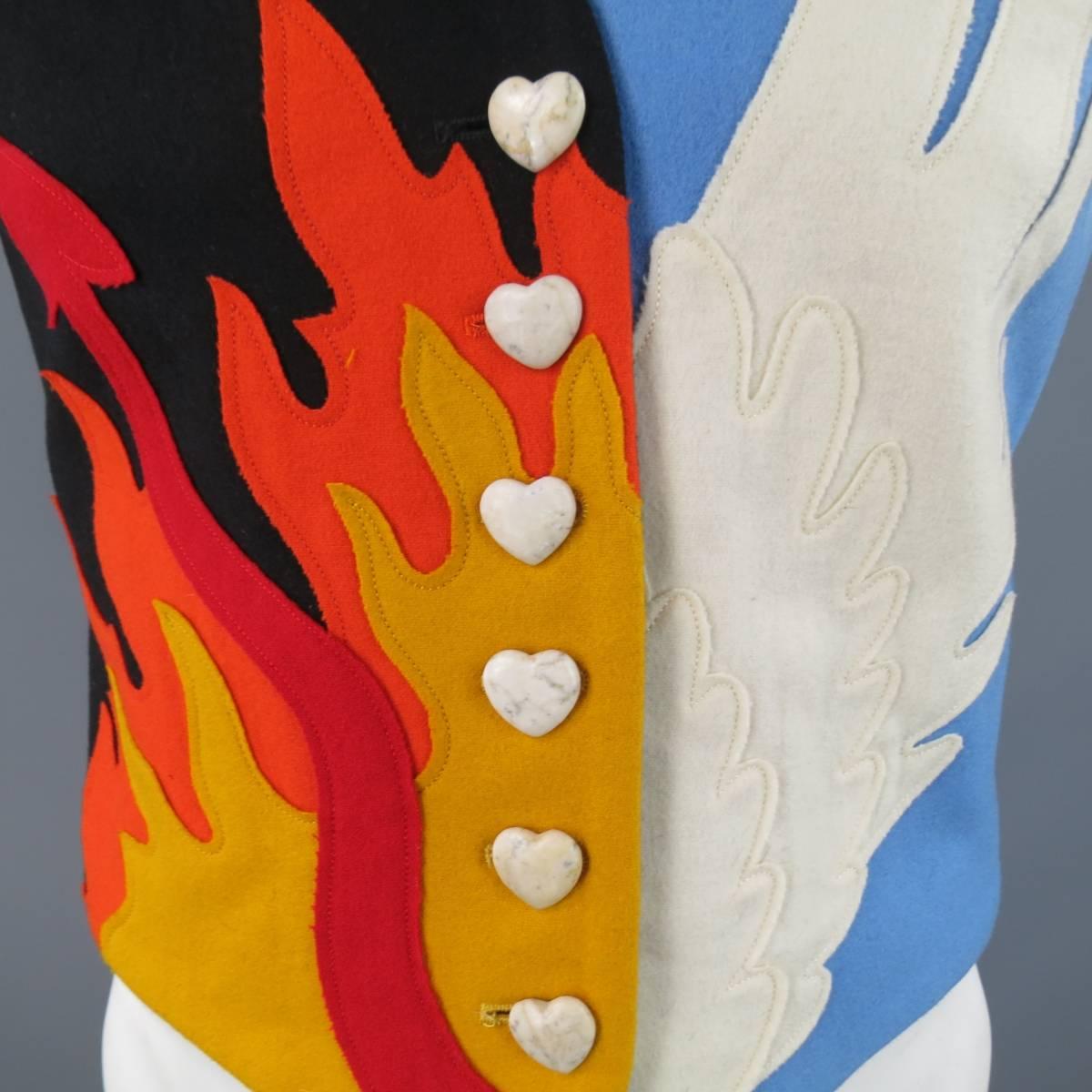 This rare vintage MOSCHINO vest features a double graphic wool felt patchwork front, one black side with gold and orange flames with a devil's tail Hell motif and the other a sky blue with gold stars and cream angel wing in a Heaven motif, and a