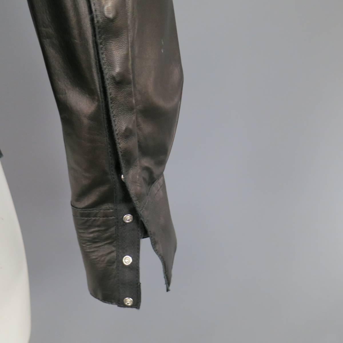 This CoSUME NATIONAL HOMME shirt comes in smooth, soft black leather with a pointed collar, and hidden placket with snap closures. Fading throughout leather from wear can be touched up by a leather professional. Made in Italy.
 
Good Pre-Owned