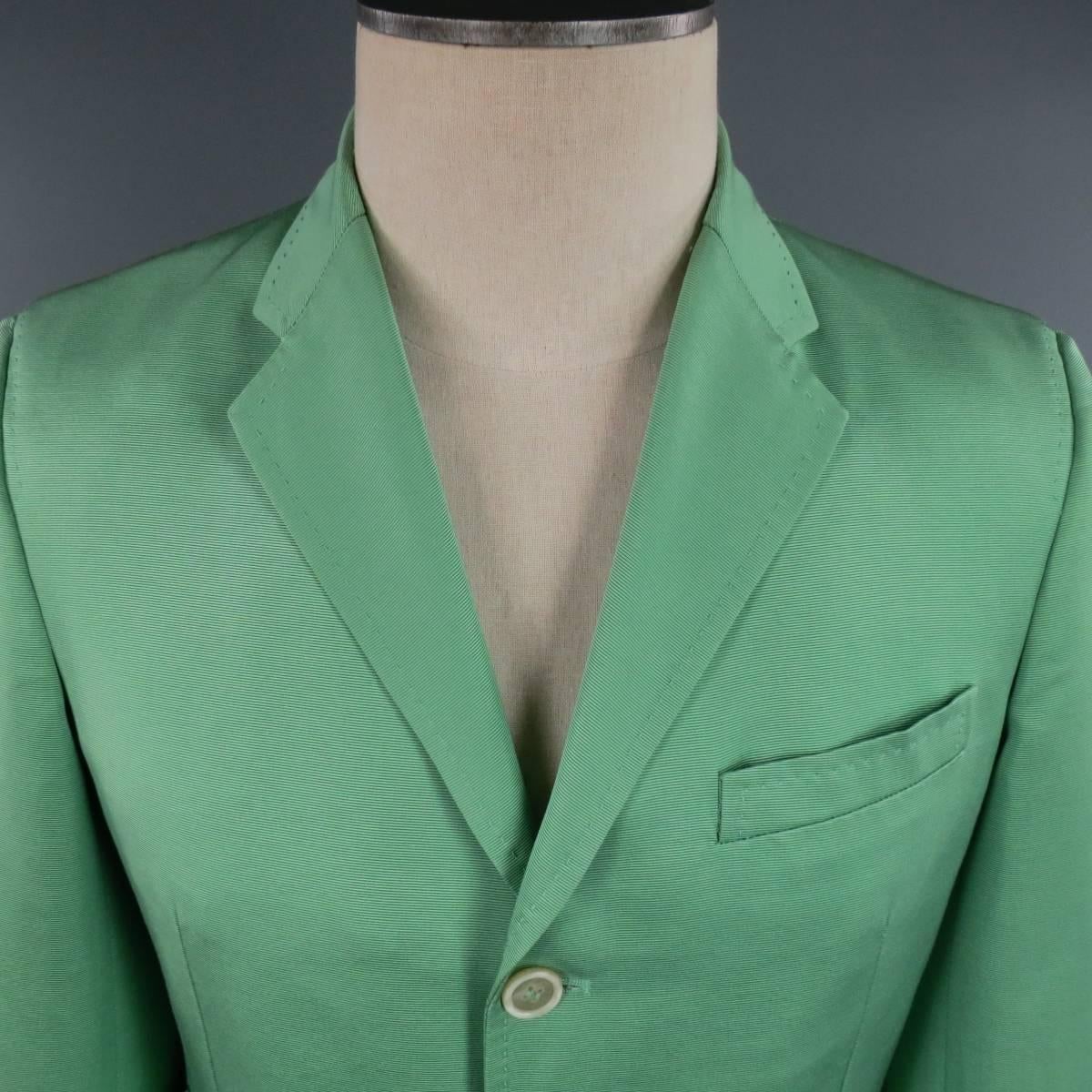 This chic DSQUARED2 sport coat comes in light green cotton silk blend ribbon textured faille fabric with a three button closure, notch lapel, triple flap pocket front, functional button sleeves, single back vent and top stitching detail throughout.