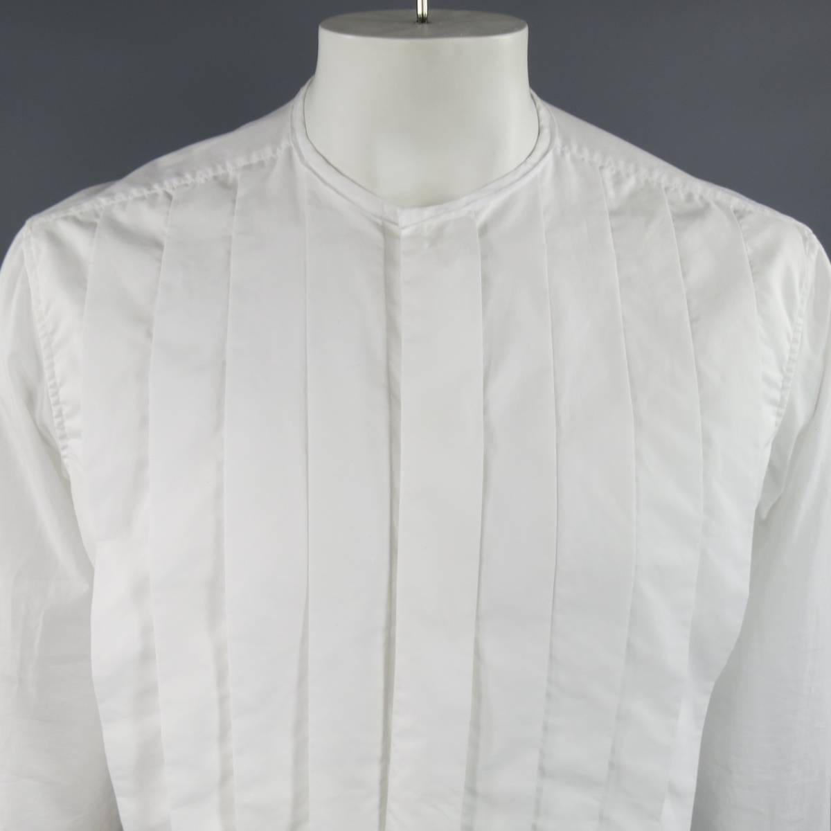LANVIN Long Sleeve Shirt consists of cotton material in a white color tone. Designed with a collarless neck line, single button cuffs and tone-on-tone stitching throughout seams. Detailed with an oversized pleated front that also hides button-up