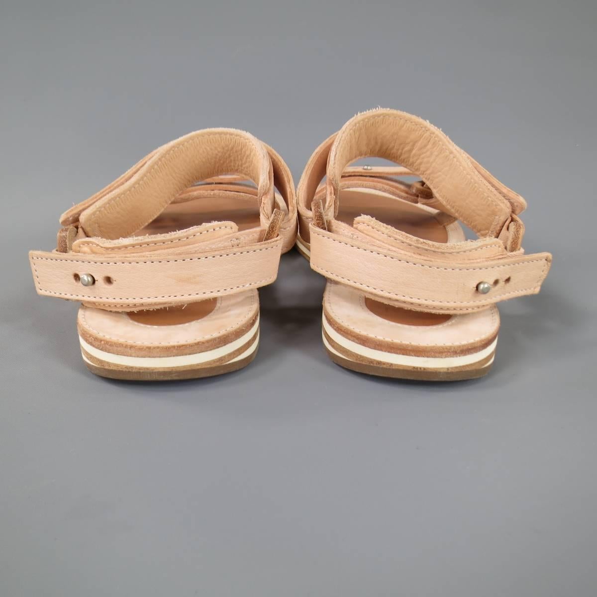 These SACAI X HENDER SCHEME sandals come in peachy beige natural Patina leather that ages and changes color with wear and features cross over toe and ankle adjustable harness straps with button studs and a stacked leather sole. With Dust Bags. Made