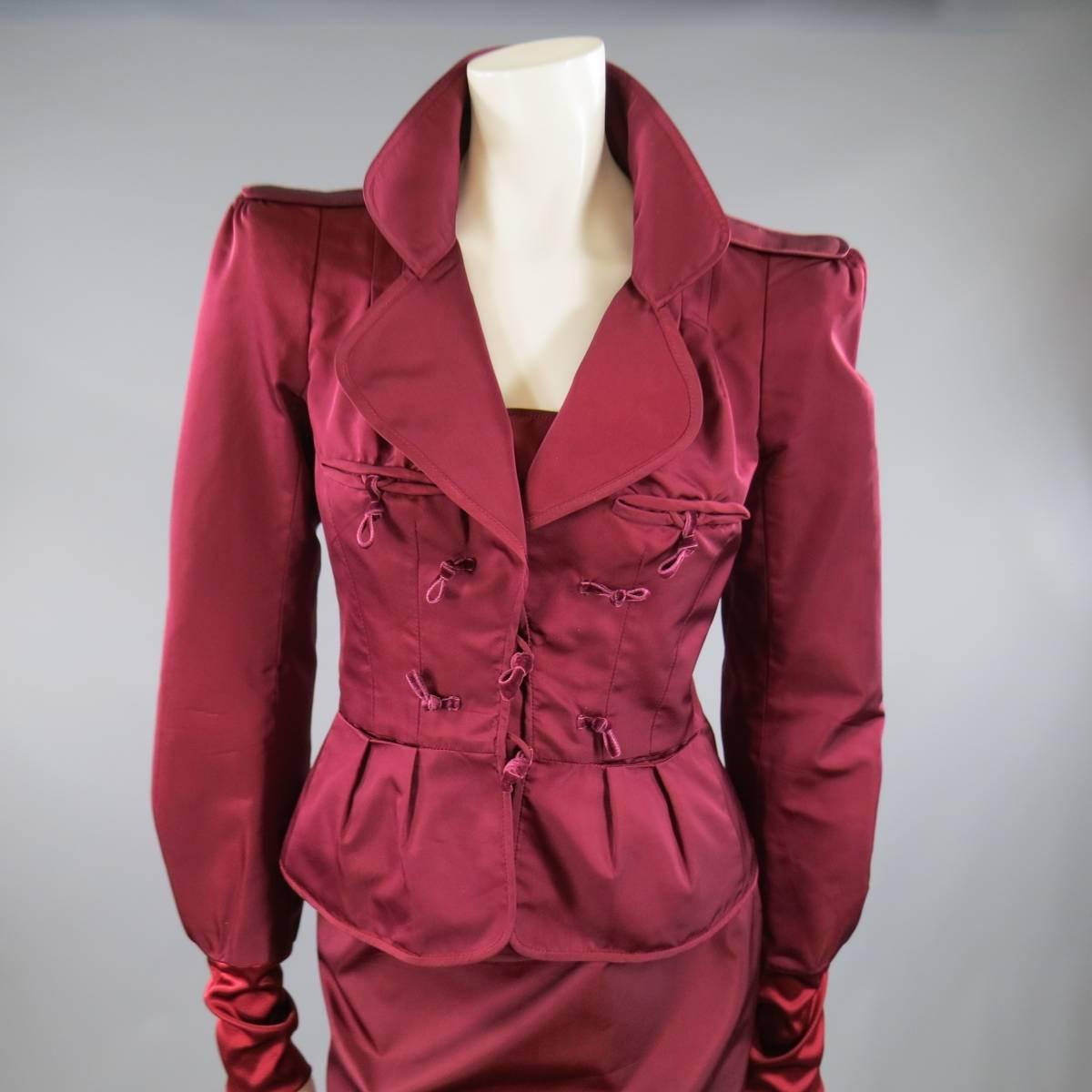 This rare archival YVES SAINT LAURENT by TOM FORD skirt suit comes in a rich Burgundy red silk semi-matte satin and includes a cropped jacket with padded epaulet shoulders, pleated peplum silhouette, long sleeves with banded cuff, and tied velvet