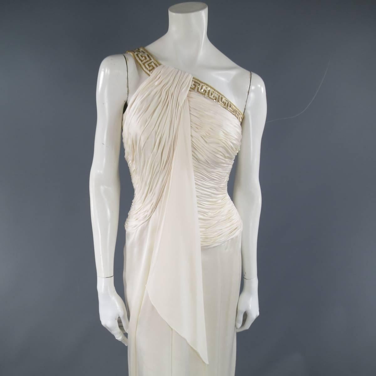 This gorgeous Grecian style evening gown by MICHAEL CASEY comes in light weight cream silk crepe satin and features a pleated bodice with ruffled column overlay panel, gold beaded one should trim strap, and slit skirt. Made in USA.
 
Excellent