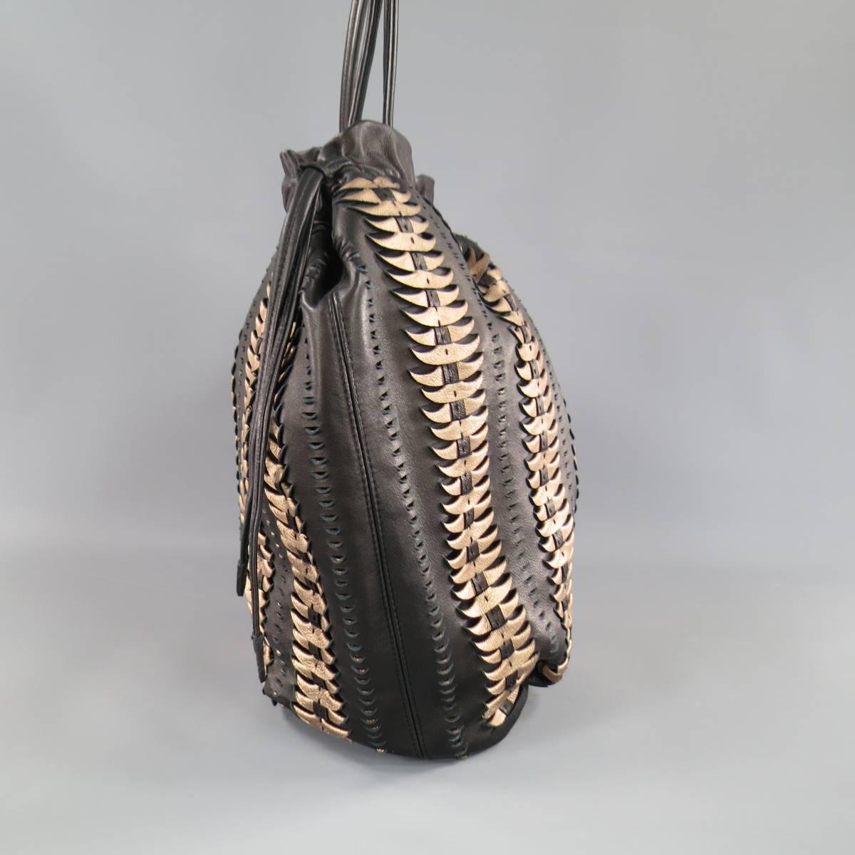 This gorgeous ELIE TAHARI tote bag comes in smooth black leather with gorgeous metallic copper pebbled leather woven in stripes throughout and features a round, pleated shape, drawstring top with side pulls & magnetic closure, and skinny shoulder