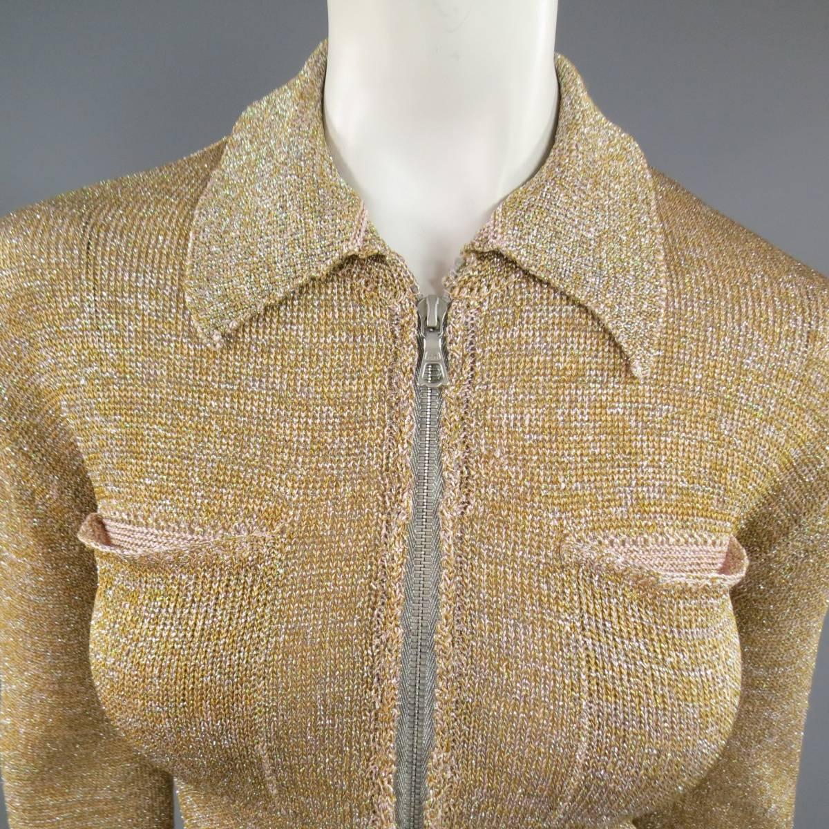This fabulous DRIES VAN NOTEN cardigan comes in a sparkling gold and pink lurex glitter knit and features a pointed collar, silver tone zipper closure, double breast pockets, and ribbed cuffs. Made in Belgium.
 
Good Pre-Owned Condition.
Marked: