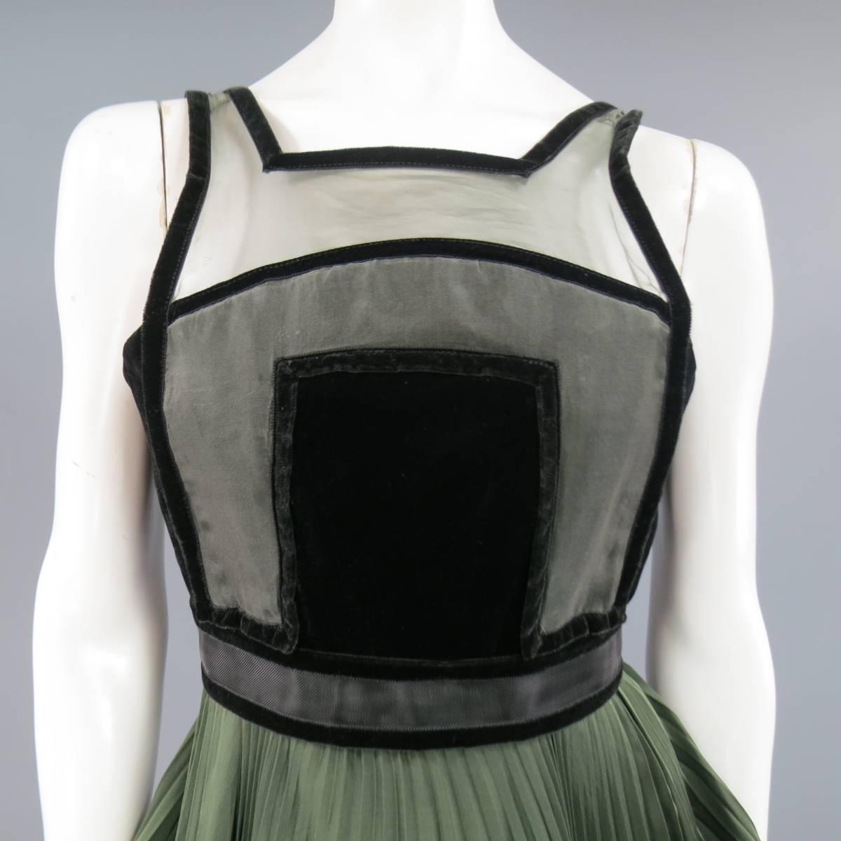 This stunning CHRISTOPHER KANE Fall Winter 2009 Collection cocktail dress features an olive boned bodice with black velvet trimmed sheer panel, and accordion pleated olive silk satin full skirt with ruffled hem trimmed in black mesh tulle.
Minor