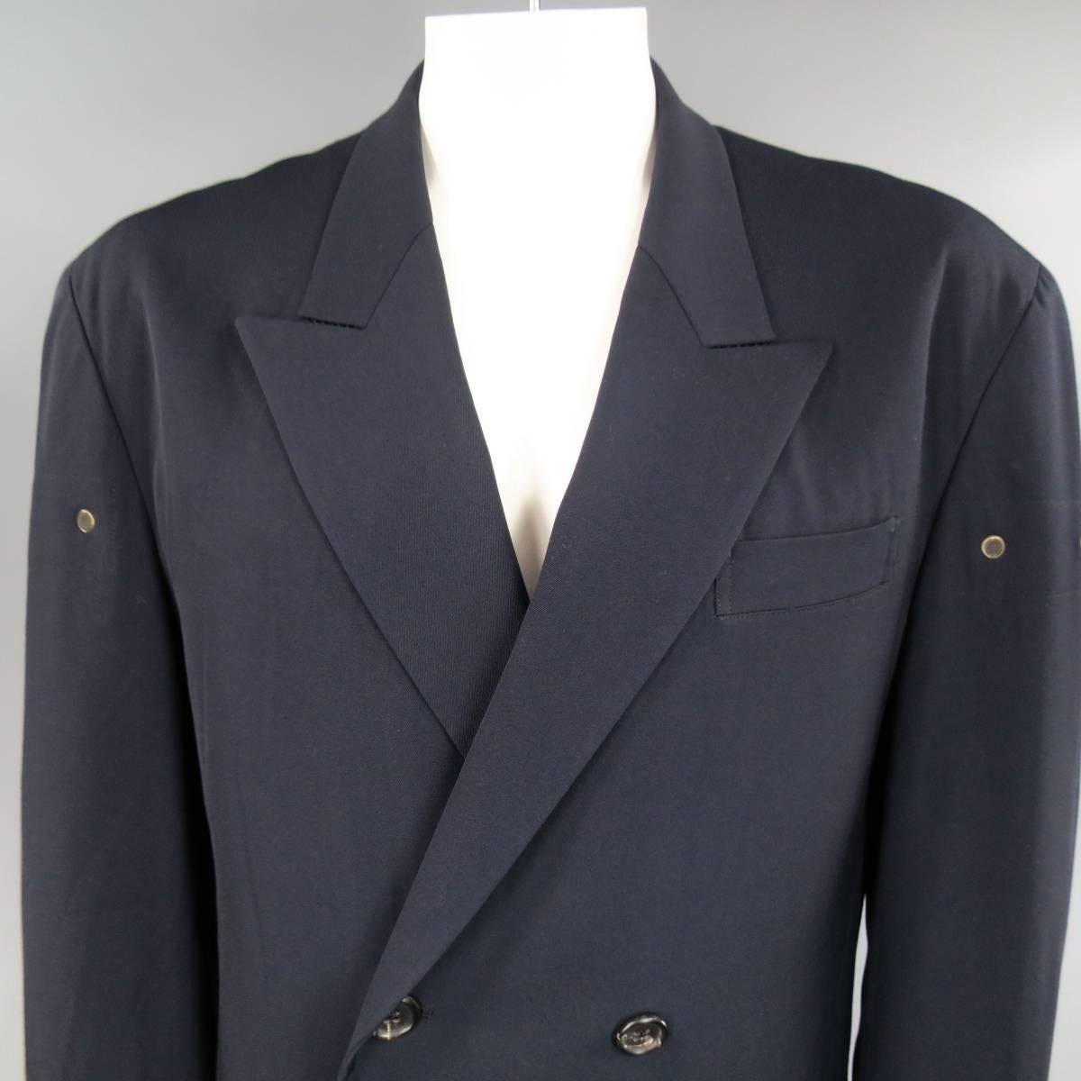 Oversized vintage Men's Yohji Yamamoto Homme sport coat in navy blue wool twill featuring a wide, peak lapel, double breasted closure, double flap pockets, ventless back, and dark gold tone metal mesh grommet vent details through mid section. Made
