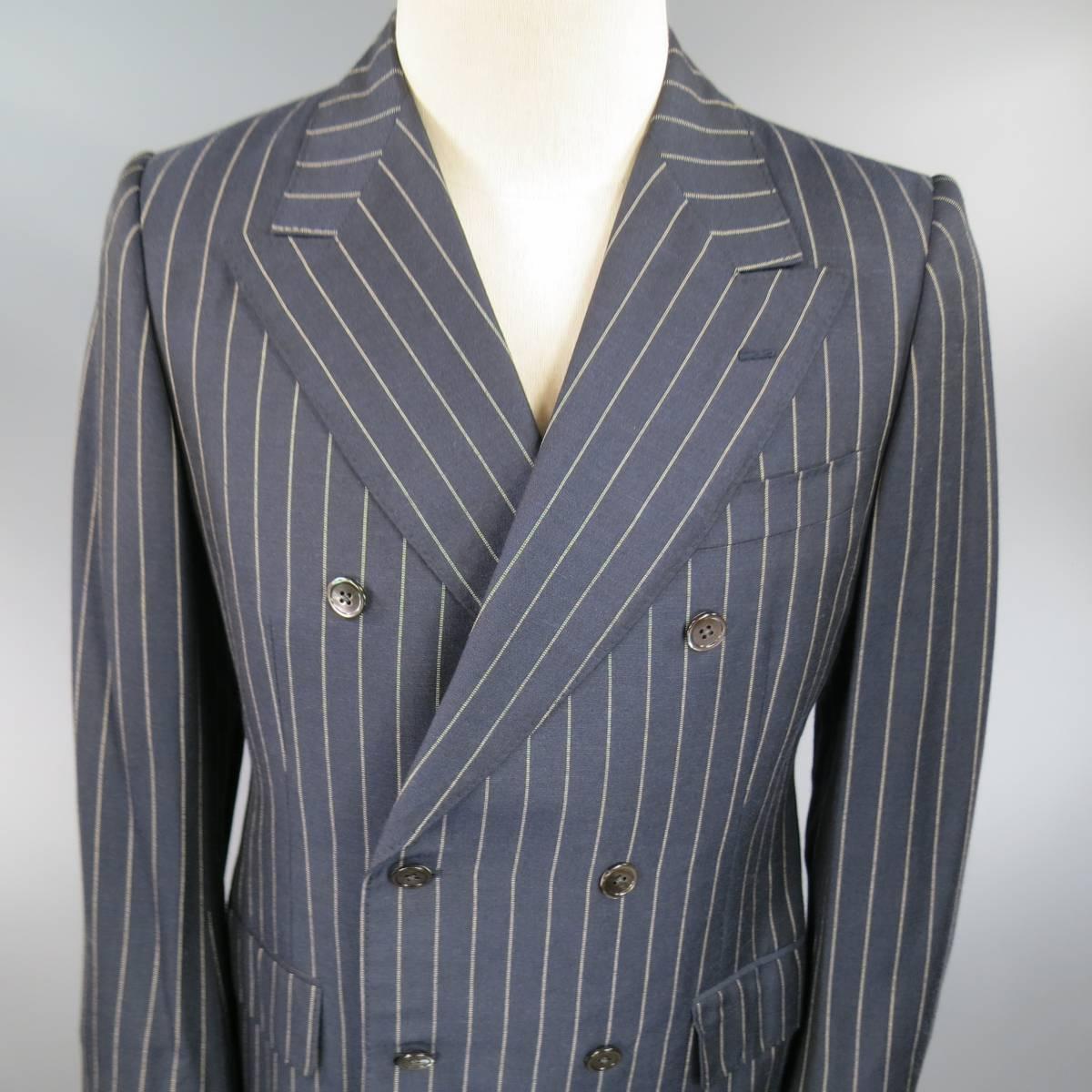 Classic chic PRADA sport coat in navy blue and beige pinstripe fabric with a peak lapel, double breasted closure, double flap pockets, tailored silhouette, and double vented back. Made in Italy.
 
Excellent Pre-Owned Condition.
Marked: IT 48 R
